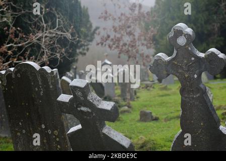 A general view of Irish tombstones and Celtic crosses inside an Early Medieval monastic settlement in Glendalough. On Monday, December 23, 2019, in Dublin, Ireland. (Photo by Artur Widak/NurPhoto) Stock Photo