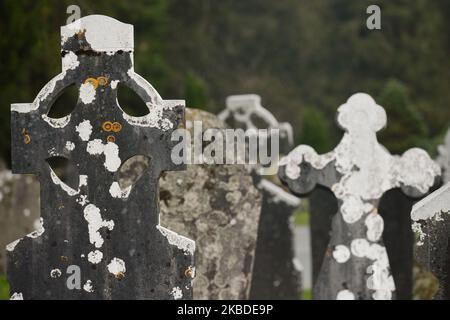 A general view of Irish tombstones and Celtic crosses inside an Early Medieval monastic settlement in Glendalough. On Monday, December 23, 2019, in Dublin, Ireland. (Photo by Artur Widak/NurPhoto) Stock Photo