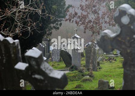 A general view of Irish tombstones and Celtic crosses inside an Early Medieval monastic settlement in Glendalough. On Monday, December 23, 2019, in Dublin, Ireland. (Photo by Artur Widak/NurPhoto) Stock Photo