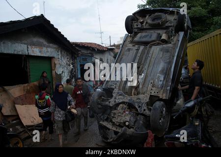 Situation after floods hit settlements in Bekasi city, West Java Province, outskirt of Capital Jakarta on Thursday, January 2nd, 2020, leaving mud, debris and demaged houses and vehicles. (Photo by Aditya Irawan/NurPhoto) Stock Photo