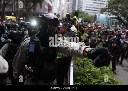 Riot police stand against demonstrators during a protest in the Wan Chai district of Hong Kong, China, on January 1, 2020. (Photo by Yat Yeung/NurPhoto) Stock Photo