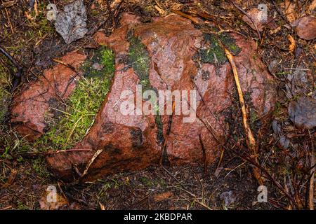 Red granite stone in nature, top view close up Stock Photo