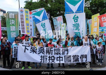 Protesters marching in Taipei, on January 5, 2020 holding flags from ...