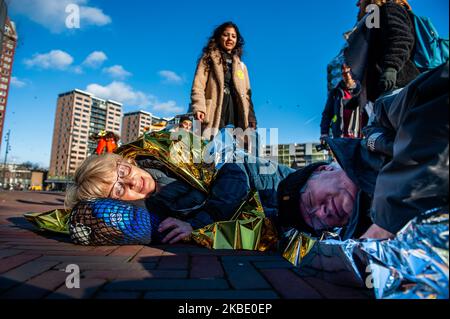 An activist is laying on the floor during a Die-in action carried by XR group in The Netherlands that took place in the center of Rotterdam, on January 6th, 2020. (Photo by Romy Arroyo Fernandez/NurPhoto) Stock Photo