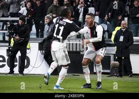 Juventus forward Cristiano Ronaldo (7) celebrates with Juventus forward Douglas Costa (11) after scoring his goal to make it 4-0 during the Serie A football match n.18 Juventus and Cagliari on January 06, 2020 at the Allianz Stadium in Turin, Piedmont, Italy. (Photo by Matteo Bottanelli/NurPhoto) Stock Photo