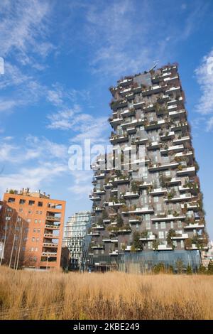 General view of Bosco Verticale (Vertical Forest) in Milan, Italy, on January 07 2020. Bosco Verticale is a pair of residential towers in the Porta Nuova district of Milan, Italy, between Via Gaetano de Castillia and Via Federico Confalonieri near Milano Porta Garibaldi railway station. They have a height of 111 metres (364 ft) and 76 metres (249 ft) and contain more than 900 trees (approximately 550 and 350 in the first and second towers, respectively) on 8,900 square metres (96,000 sq ft) of terraces. Within the complex is an 11-storey office building; its facade does not include plants. The Stock Photo