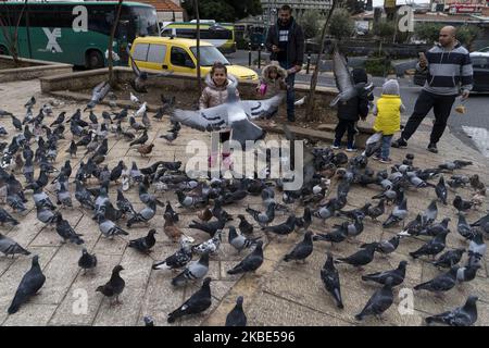 Some children feed the pigeons in the city of Nazareth, Israel, on 10 December 2019. It is the most populous city in the Northern District of Israel, in the southern foothills of the mountains of Lower Galilee, 10 km north of Mount Tabor and 23 km west of the Sea of Galilee. It is currently the city with the largest Arab population in Israel. (Photo by Joaquin Gomez Sastre/NurPhoto) Stock Photo
