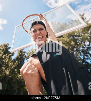 Basketball, man and winner in score for sports game, celebration or match in the court outdoors. Excited, energetic male basketball player celebrating Stock Photo
