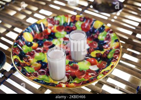 Traditional Assamese alcoholic drink called rice beer pictured on the floor in the kitchen of a bamboo house at Majuli island, Assam, India on 6 March, 2019. (Photo by Krystof Kriz/NurPhoto) Stock Photo