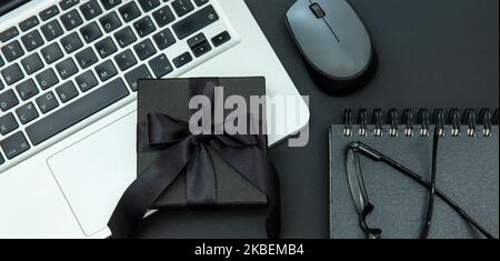 Cyber Monday and Black Friday Sale. Gift box, and computer laptop on office desk, top view. Winter Holiday Sales concept Stock Photo