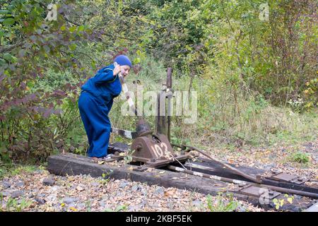 autumn boy playing on the railroad track Stock Photo