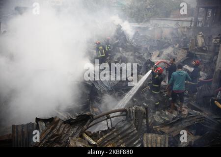 Bangladeshi firefighters extinguish a fire that broke out at Chalantika ...