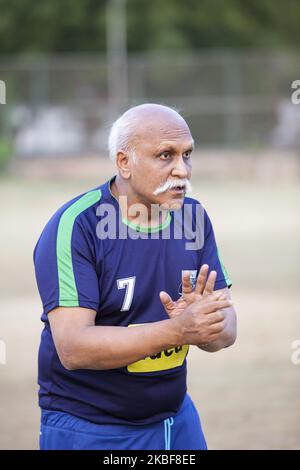 Training of FC Simla Youngs football club in Delhi, India on 2 April, 2018. Coach Tushar Dev gives instruction to players. The conditions in India for top football (soccer) are difficult. The heat - the season in lower competitions is only two months, ie in March and April. Poor surfaces and smog are also problematic. Simla Youngs is a club that was founded in 1936 and is one of the most traditional in India. Recently, clubs like Barcelona Gurgaon, Paris Saint Germain started to open their soccer academies, fees at such academies are not cheap. Trainers come from Europe for trainings, world ch Stock Photo