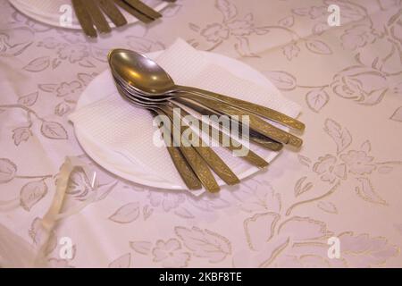 set of table spoons lie on a white plate Stock Photo