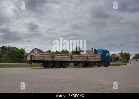 truck on the road transports a red brick Stock Photo