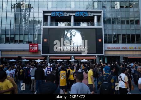 Fans gather at a makeshift memorial to mourn the death of NBA legend Kobe Bryant, who was killed along with his daughter and seven others in a helicopter crash on January 26, at LA Live plaza in front of Staples Center in Los Angeles on January 27, 2020. - (Photo by Brent Combs/NurPhoto)