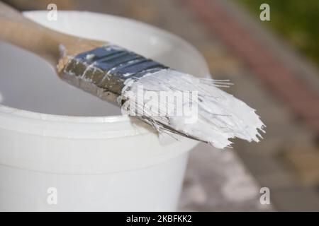 Paint brush resting on paint tin viewed from above Stock Photo