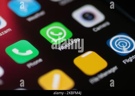 WhatsApp logo displayed on a phone screen, smartphone and keyboard are seen in this multiple exposure illustration. WhatsApp Messenger is a multiplatform mobile application that provides an encrypted instant messaging system belonging to Facebook, photo taken in Amsterdam, Netherlands on January 28, 2020 (Photo illustration by Nicolas Economou/NurPhoto) Stock Photo