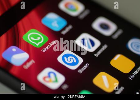WhatsApp logo displayed on a phone screen, smartphone and keyboard are seen in this multiple exposure illustration. WhatsApp Messenger is a multiplatform mobile application that provides an encrypted instant messaging system belonging to Facebook, photo taken in Amsterdam, Netherlands on January 28, 2020 (Photo illustration by Nicolas Economou/NurPhoto) Stock Photo