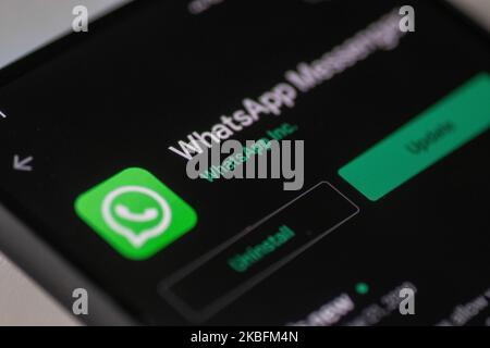WhatsApp logo displayed on a phone screen, smartphone and keyboard are seen in this multiple exposure illustration. WhatsApp Messenger is a multiplatform mobile application that provides an encrypted instant messaging system belonging to Facebook, photo taken in Amsterdam, Netherlands on January 28, 2020 (Photo illustration by Nicolas Economou/NurPhoto) Stock Photo