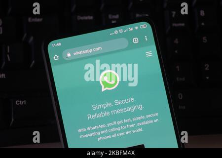 WhatsApp logo displayed on a phone screen, smartphone and keyboard are seen in this multiple exposure illustration. WhatsApp Messenger is a multiplatform mobile application that provides an encrypted instant messaging system belonging to Facebook, photo taken in Amsterdam, Netherlands on January 28, 2020 (Photo illustration by Nicolas Economou/NurPhoto) Stock Photo