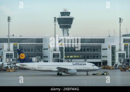 A Lufthansa Airbus A320 with registration D-AIZF in front of the terminal and control tower of Munich Airport. Early morning airplane traffic movement of Lufthansa aircraft with their logo visible on the tarmac and docked via jetbridge or air bridge at the terminal at Munich MUC EDDM international airport in Bavaria, Germany, Flughafen München in German. Deutsche Lufthansa DLH LH is the flag carrier and largest airline in Germany using Munich as one of their two hubs. Lufthansa is a Star Alliance aviation alliance member. January 26, 2020 (Photo by Nicolas Economou/NurPhoto)
