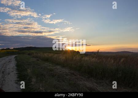 the landscape in nature comes in the evening and the sun hides behind the horizon Stock Photo