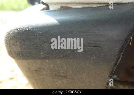 scratch on bumper of car, Bumper car scratched with deep damage to the paint. Dent car scratch. Crashed car in accident. Stock Photo
