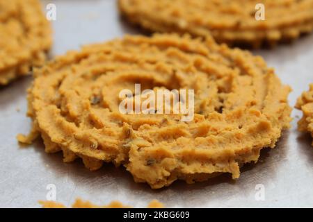 Raw chakali in plate. Indian Traditional Tea Time Snack Chakli, a deep fried snack, It is known as Chakali, Murukku, Muruku, Murkoo, Chakri. Stock Photo