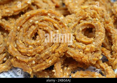 Raw chakali in plate. Indian Traditional Tea Time Snack Chakli, a deep fried snack, It is known as Chakali, Murukku, Muruku, Murkoo, Chakri. Stock Photo