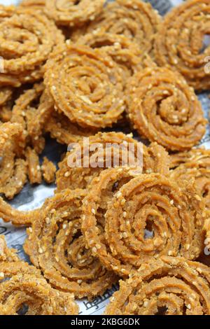 Raw chakali in plate. Indian Traditional Tea Time Snack Chakli, a deep fried snack, It is known as Chakali, Murukku, Muruku, Murkoo, Chakri. Stock Photo