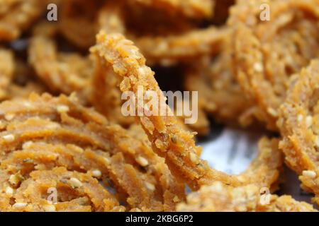 Raw chakali in plate. Indian Traditional Tea Time Snack Chakli, a deep fried snack, It is known as Chakali, Murukku, Muruku, Murkoo, Chakri. Stock Photo