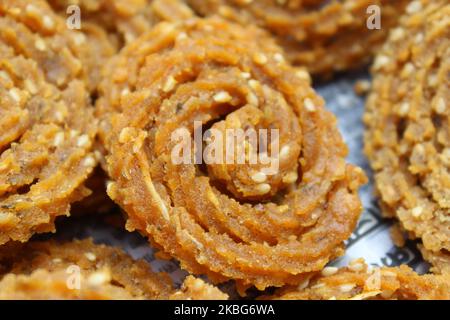 Raw chakali in plate. Indian Traditional Tea Time Snack Chakli, a deep fried snack, It is known as Chakali, Murukku, Muruku, Murkoo, Chakri. Stock Photo