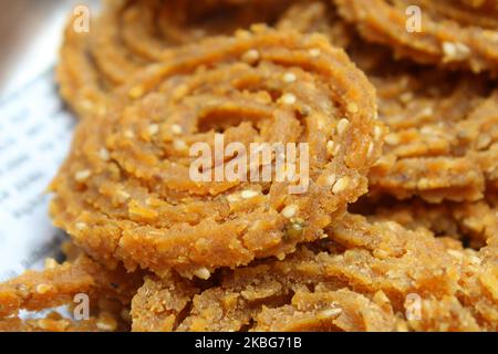 Raw chakali in plate. Indian Traditional Tea Time Snack Chakli, a deep fried snack, It is known as Chakali, Murukku, Muruku, Murkoo, Chakri. Stock Photo