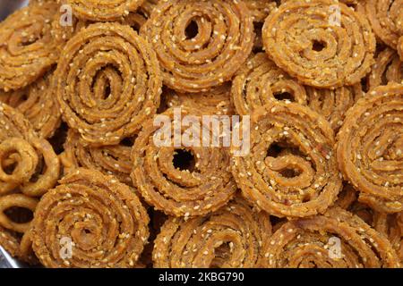 Raw chakali in plate. Indian Traditional Tea Time Snack Chakli, a deep fried snack, It is known as Chakali, Murukku, Muruku, Murkoo, Chakri. Stock Photo