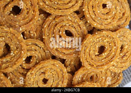 Raw chakali in plate. Indian Traditional Tea Time Snack Chakli, a deep fried snack, It is known as Chakali, Murukku, Muruku, Murkoo, Chakri. Stock Photo