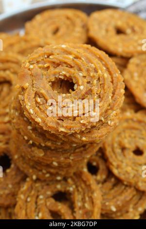 Raw chakali in plate. Indian Traditional Tea Time Snack Chakli, a deep fried snack, It is known as Chakali, Murukku, Muruku, Murkoo, Chakri. Stock Photo