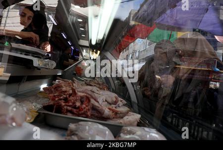 A Palestinian man displays chickens for sale at a market in Gaza City on February 4, 2020. (Photo by Majdi Fathi/NurPhoto) Stock Photo
