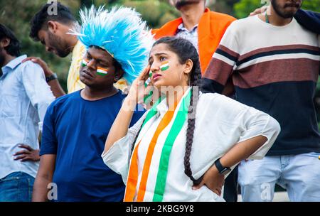 worried Girl with painted Indian flag on face got sad while watching sports match at stadium due to loss of wicket in cricket - concept of tournament Stock Photo