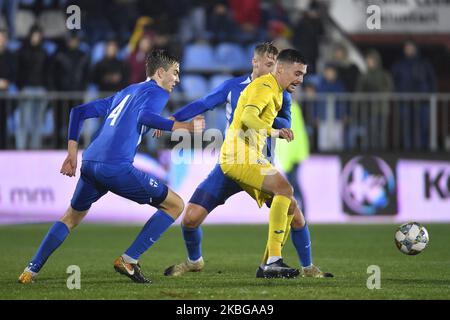 Adrian Petre of Romania U21 in action against Juhani Pikkarainen of Finland U21 during the game of UEFA U21 championship between Romania U21 v Finland U21, in Voluntari, Romania, on November 14, 2019. (Photo by Alex Nicodim/NurPhoto) Stock Photo