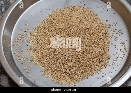 Organic White Sesame seeds (Sesamum indicum) or white Til in steal plate Stock Photo