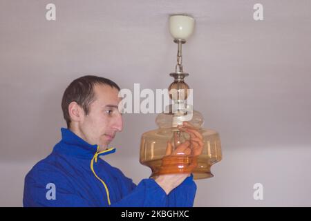 Hands of electrical screwed energy saving light bulbs Stock Photo