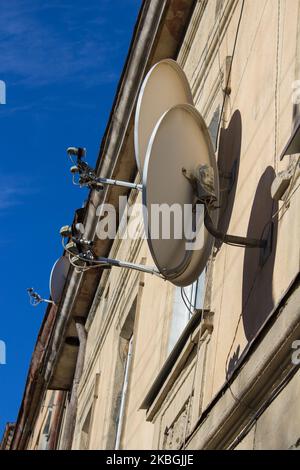 Two satellite dish and television antenna on roof top, beautiful light make with filter Stock Photo