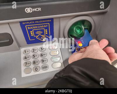 Man using a MasterCard card to get money from the ATM is seen in Gdansk, Poland on 10 January 2020 (Photo by Michal Fludra/NurPhoto) Stock Photo