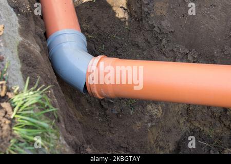 laying sewer pipes in the ground from the house Stock Photo