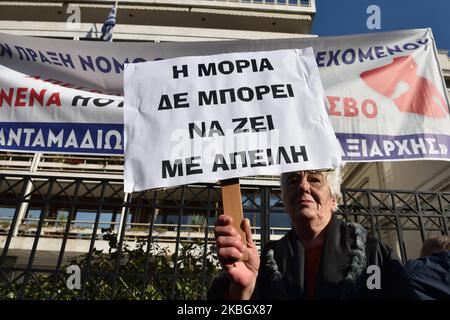 A woman holds a placard that reads ''Moria can't live under threat'' as island residents protest on February 13, 2020 in central Athens, Greece against a recent legislative act which allows the government to proceed with the requisition of properties and land in order to construct new closed migrant camps. (Photo by Nicolas Koutsokostas/NurPhoto) Stock Photo