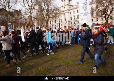 Young environmentalists take part in a 'climate strike' demonstration organised by the youth-led 'Fridays For Future' activist movement in Parliament Square in London, England, on February 14, 2020. The event marks one year since the first global wave of climate strike protests brought hundreds of thousands of schoolchildren onto the streets in cities around the world to call for greater action from governments to tackle the climate crisis. Several such coordinated global events have since been held, with worldwide climate activism over the past year further bolstered by the tandem growth of t Stock Photo