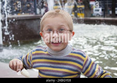 cheerful boy laughing in the background Fountain Stock Photo