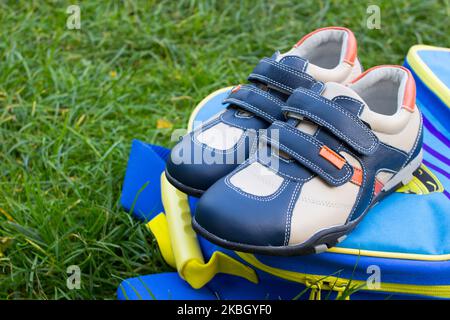 children's sneakers on a school backpack Stock Photo
