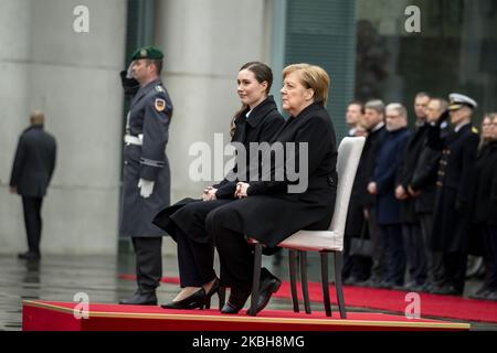 German Chancellor Angela Merkel (R) and new Finnish Prime Minister Sanna Marin (L) listen to the national anthems at the Chancellery in Berlin on February 19, 2020. (Photo by Emmanuele Contini/NurPhoto) Stock Photo